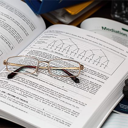 Photo of book with reading glasses